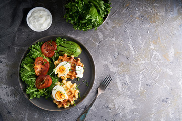 Healthy organic breakfast. Waffles, herbs, tomatoes,salad,eggs, spices served in a plate