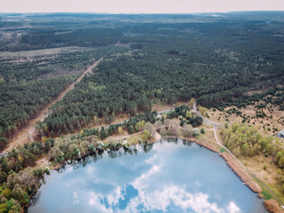 Fototapeta na wymiar aerial photography of a forest lake with reflected clouds