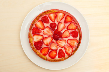 Delicious homemade strawberry tart. Isolated on wooden background. Top view. Horizontal shot.