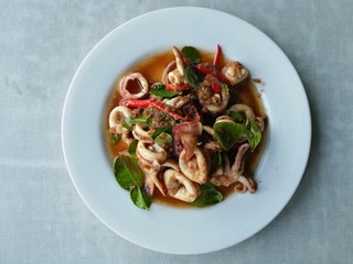 Thai Basil Squidof homemade local street food seafood authentic and exotic menu from asia, Thai culture. Made squid fry with herbs, chili and lemongrass and shrimp paste