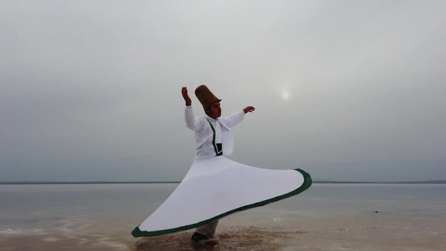 sunset and whirling at the sea, sufi. sufi whirling (Turkish: Semazen) is a form of Sama or physically active meditation which originated among Sufis. 4k
