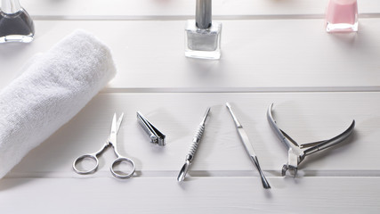Equipment for beauty shop or beauty parlour.Set for home manicure and nail care. Manicure or pedicure set tools are placed on a table with a white towel in the beauty salon.