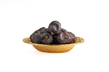 Ajwa Dates fruits or dry dates isolated on white background.Ramadan Kareem Breaking the fast by eating Tamar Dates
