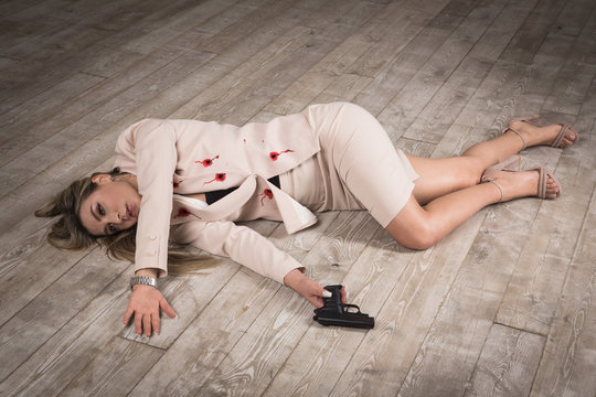 Crime scene (imitation). Pretty business woman lying on the floor. She shot in the chest.