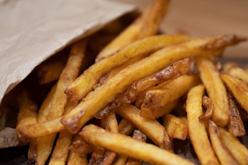 Homemade authentic healthy oil free fresh delicious golden real organic potato french fries wedges with natural skins with salt, pepper, mayonnaise, ketchup sauce. Tasty vegetarian appetizer meal