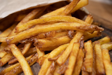 Homemade authentic healthy oil free fresh delicious golden real organic potato french fries wedges with natural skins with salt, pepper, mayonnaise, ketchup sauce. Tasty vegetarian appetizer meal