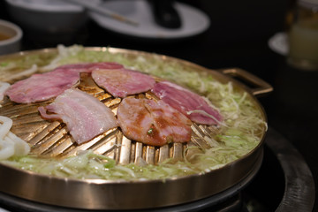 Empty Asian Thai Korean hot pot restaurant, grill on barbecue BBQ buffet metal stove with pork, beef, and vegetables. Sale food drop bankrupt due to coronavirus lockdown social distancing