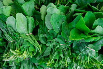 Freshly picked spinach on a street food and vegetable market, selective fokus