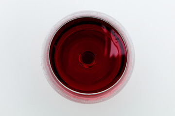 Glass of red wine on a white background. View from above - 344543701