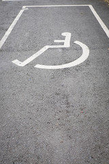 A sign on the pavement - disabled car parking