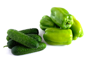 Green peppers and cucumbers on a white background. Vegetables