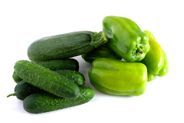 Green peppers, zucchini and cucumber on a white background. Vegetables