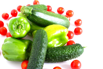 Green vegetables and small tomatoes are lying. Isolate
