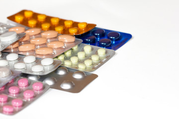 Pills in a blister pack close-up. Painkillers. Protection from coronovarus Covid19. Colored tablet packages. Medicine for the first-aid kit.