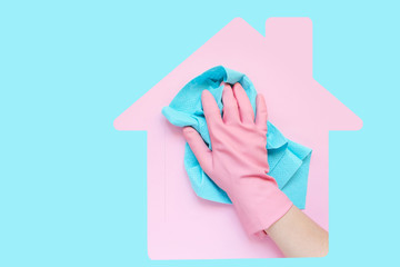 Employee hand in rubber protective glove with micro fiber cloth wiping wall from dust. Maid or...