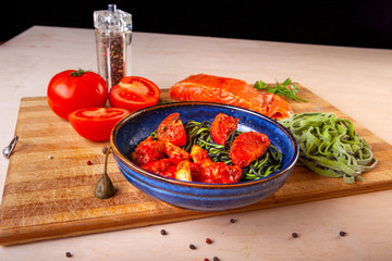 cooked pasta in a plate on a wooden board in the studio