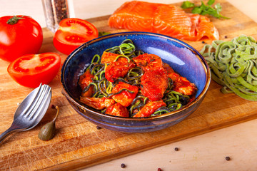 cooked pasta in a plate on a wooden board in the studio