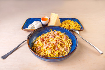 cooked pasta in a plate on a wooden board in the studio