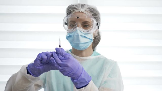Portrait of a nurse preparing for vaccination.