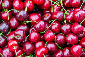 Background of many cherry berries at fruit and vegetables street Market, organic ecological food from local producers