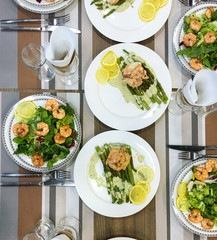 Salad of fried shrimp, arugula and lemon. Table setting. Top view.