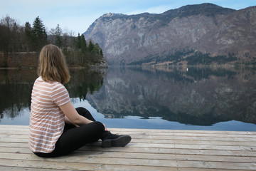 Fototapeta na wymiar young woman sitting on a pier