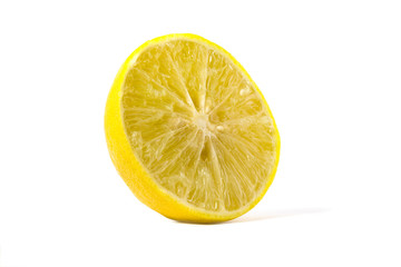 Picture of yellow lemon sliced in half with a 45 degree view On a white background
