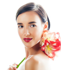 Fototapeta na wymiar young pretty brunette woman with red flower amaryllis close up isolated on white background. Fancy fashion makeup, bright lipstick, creative Ombre manicured nails. spa skin care