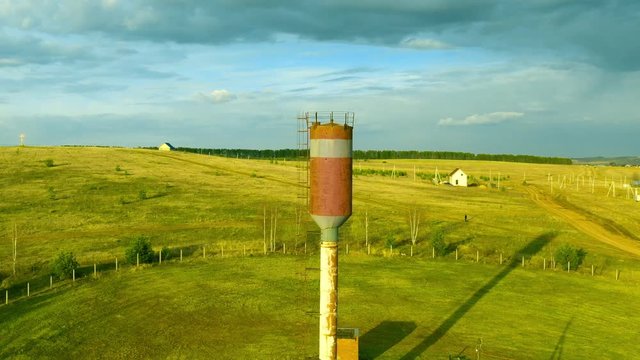Old rusty water tower in village