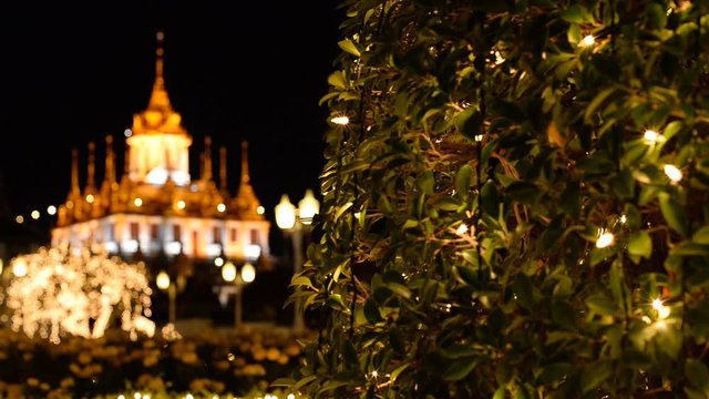 Loha Prasada having metal spires illuminated at night located at Wat Ratchanatdaram, Bangkok, Thailand