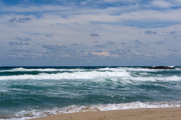 seaside waves blue white clouds background