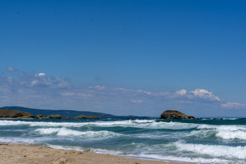 seaside waves blue white clouds background