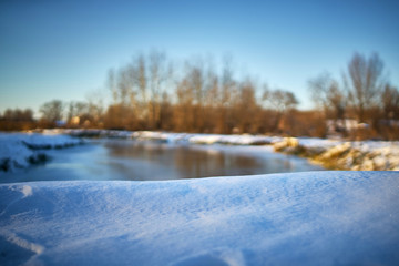 Fototapeta na wymiar Warm winter landscape of sunset blue sky with water