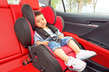 A little boy was sitting in a car safety seat