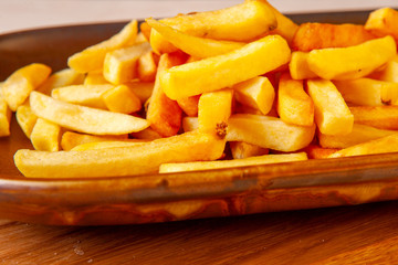 fried potatoes with a golden crust on a plate in the studio
