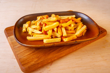 fried potatoes with a golden crust on a plate in the studio