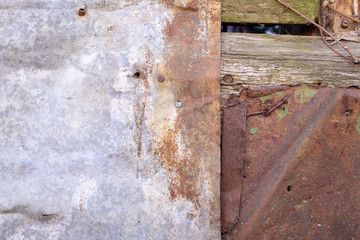Zink metal surface rusted placed on plank surface. Corroded and vintage background.