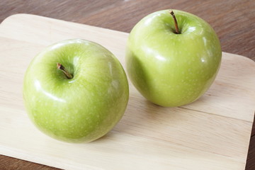 Green apples on the wood board
