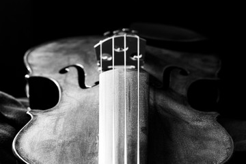 Artful black and white photo of a dusty violin body