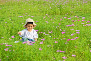 An Asian boy sat in the flowers