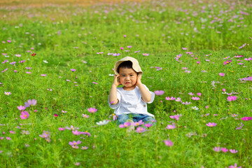 An Asian boy sat in the flowers