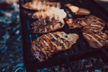 Racks of pork bbq ribs sitting on smoker grill with smoke coming from grill