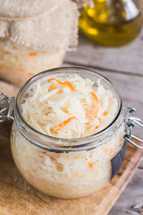 Sauerkraut fermented salad. Homemade fresh pickled cabbage (german sauerkraut) with ingredients in jar