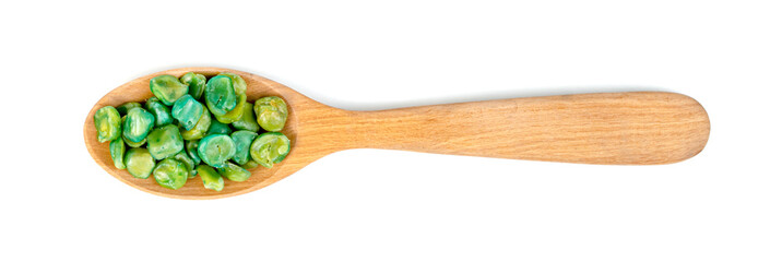 Green peas roasted in wooden spoon isolated on white background