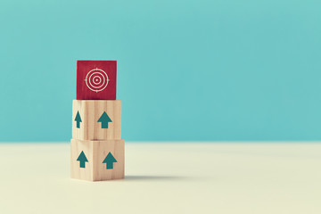 Goal achievement. Career growth and development. Reach goal. Wooden cubes with red block on top, up...