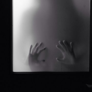 Woman Hands Looks Through Frosted Glass