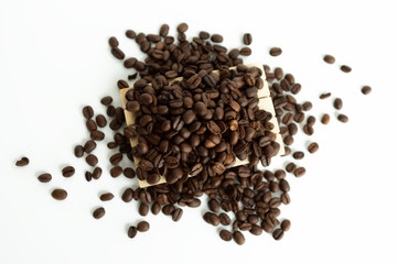 Coffee beans lying on on small wooden pallet