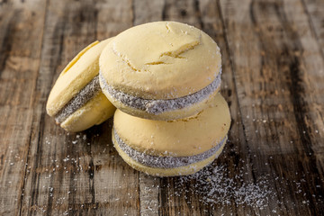 cornstarch alfajor with dulce de leche and homemade coconut in squares on wood