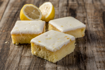 Fototapeta na wymiar homemade lemon cake in squares on wood