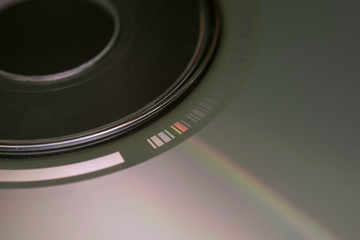Macro detail of light diffraction on a compact disc, with barcode detail